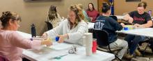 Participants of the Friends of the Valentine Public Library Puzzle Tournament begin the unboxing process Saturday morning. This group was putting together the 500 piece puzzle.