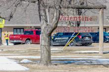 Looking over the north lawn at Valentine High School, you can see the Methodist Church in the background, a school crossing guard waving, along with a Valentine Police Department vehicle. The scene indicates that the incident March 2, 2023, was a hoax; taken a little after 11:00 a.m. the day the “active shooter” at VHS was called into 911. Photo by Laura Vroman