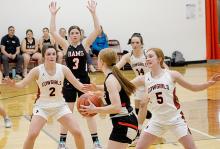 Above, the Cowgirls are trying to gain access to the ball! Bottom left, Trey Hand #23 keeps the ball moving against the Warriors Photos by Shontell Roseberry
