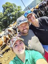 Pictured from L to R: Dr. BaiLee McMillan, Adrian Marti and Cornelia. In the background you can see the dairy heifers.