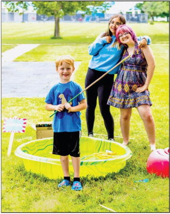 Lilybet Rolfe mans the fishing game. The girls each made five games for everyone to enjoy. Photos by Laura Vroman