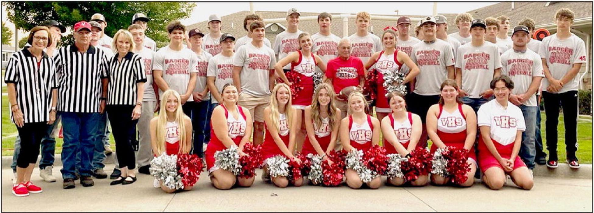 Dick Shamis was named Hometown Hero and is pictured flanked on either side by VHS cheerleaders.