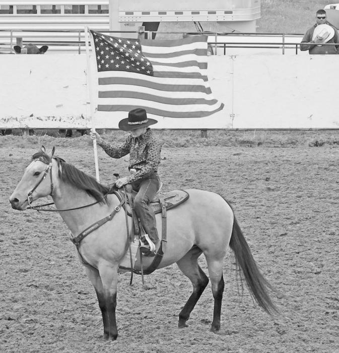 Judy Reece displays Old Glory for the National Anthem.