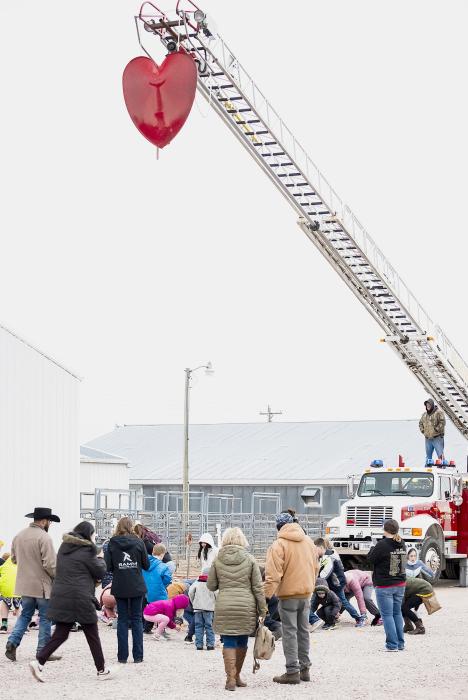 The youth waste no time in gathering up the prize winning pingpong balls in the annual Valentine’s Day celebration, on a chilly, windy, overcast February 14, 2024. Volunteer Firefighters Billy Beel and Tadd Buechle raised the heart from the ladder engine. Photos by Laura Vroman and Carolyn Moore
