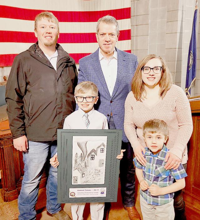 Second place by Gunnar Fernau, of Valentine Elementary School, Stay Inside During a Storm. Gunnar is photographed with his family along with Governor Jim Pillen.
