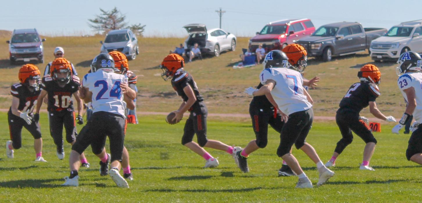 CK freshman quarterback Bentley Ford #4, handing off the football to junior Tripp Hill #11,with freshman Knox Wobig #10, as a lead blocker in action against the Arthur County Wolves.
