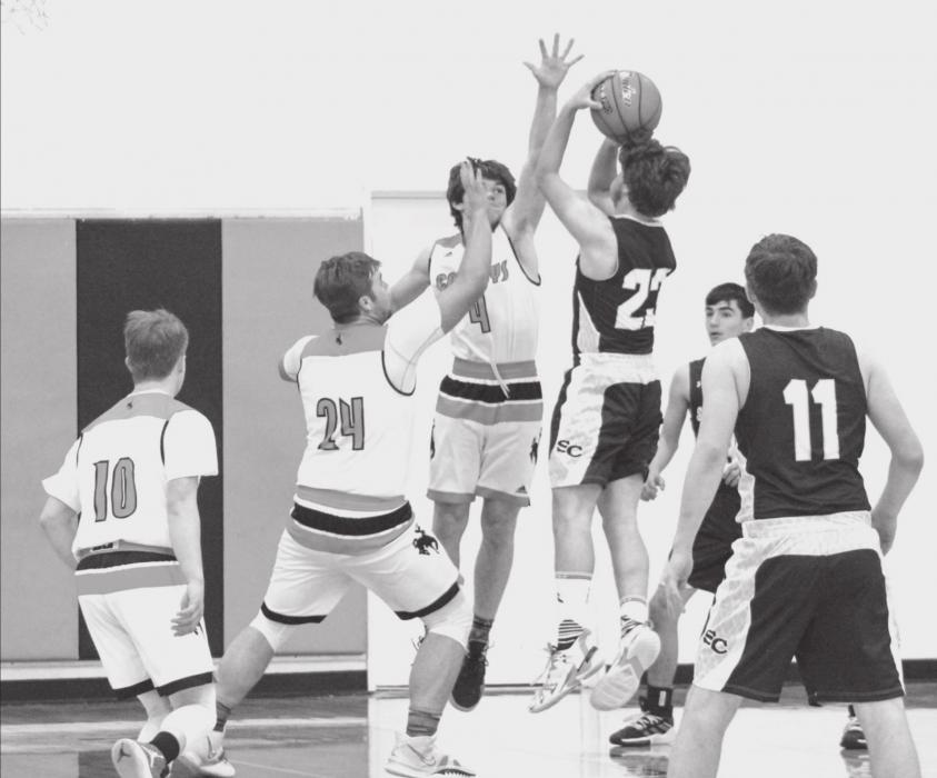 Photos by Shontell Roseberry Cooper Fay #10, Tucker Ravenscroft #24, and Jacob Knox #4, attempt a block against Sioux County.