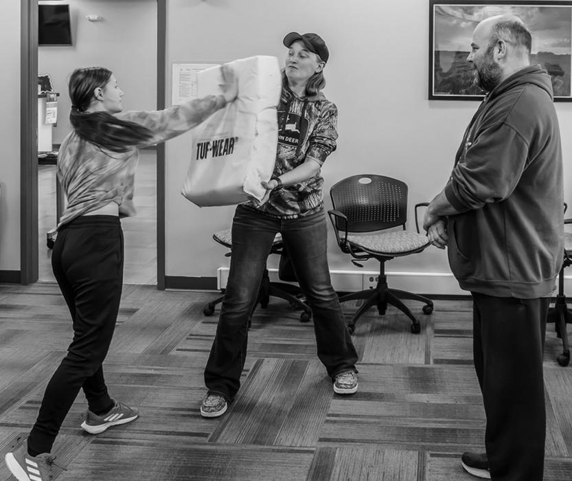 Correctional Officer Whitney Barnes and Jail Sergeant David Stoeger help with the exercises that were taught during the Women’s Self Defense class.