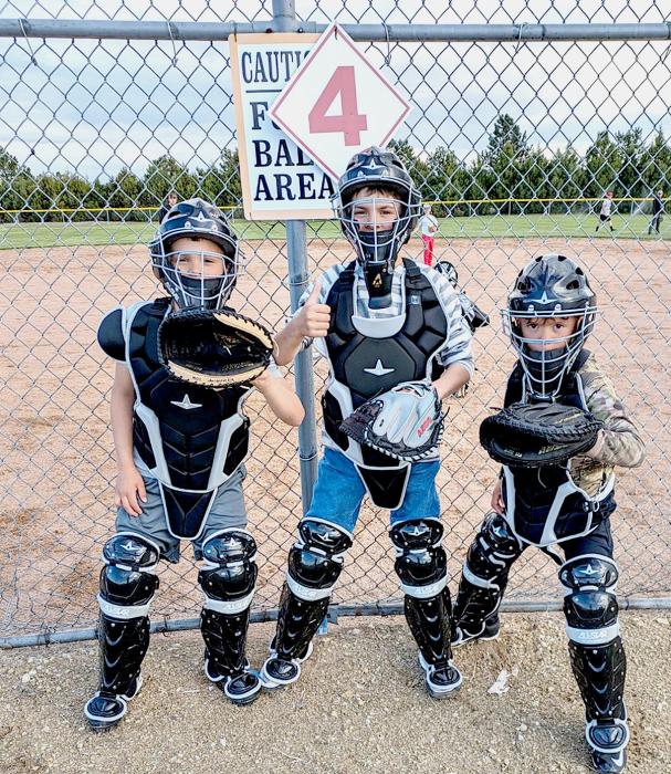 New catcher’s gear for the little boys baseball program purchased through fundraising. Pictured are from L to R: Bohdy Assman, Sterling Assman, and Jehtt Assman.