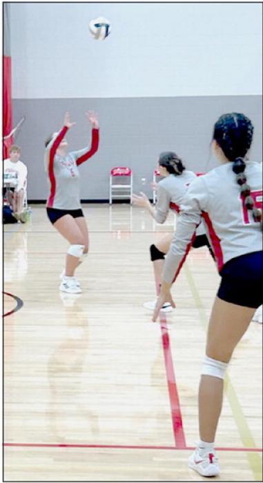 Kimber McGinley prepares to set to either Savannah Fullerton or Ariana Blume in the game against Coazd.