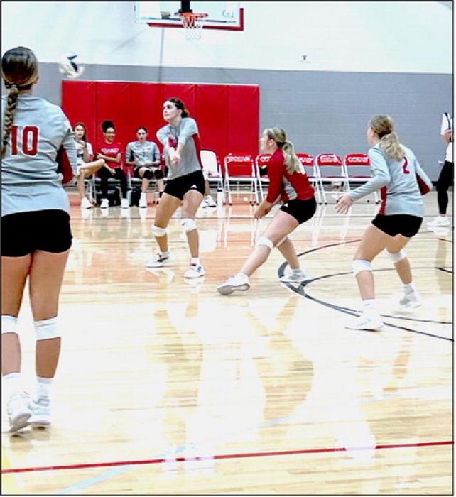 Finley Mosner receives the serve as libero Cadence Swanson and DS Caitlynn Mack provide backup in their win over Coazd. Photos by Kara Buechle