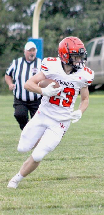 Jacob Knox #23 carrying the ball with his eyes on a first down.