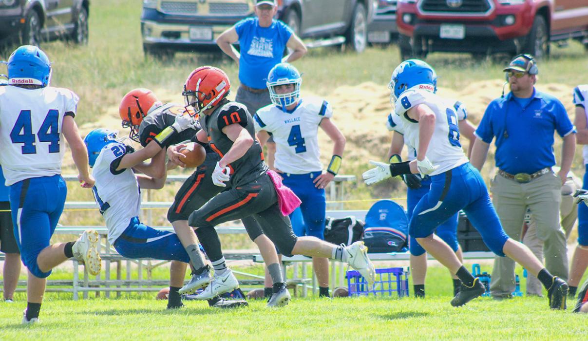 Jasper Roseberry clears a path for #10 Cooper Fay in the home game against Wallace Wildcats, Friday, August 26, 2022. Photos by Shontell’s Smiles