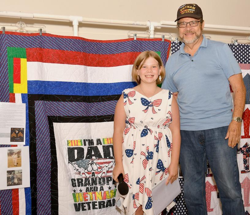 Darby Murphy presents William “Bill” Hayes with his Quilt of Valor.
