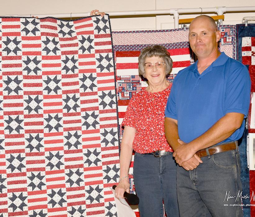 Judy Roosa presents Brandon Subjeck with his Quilt of Valor.