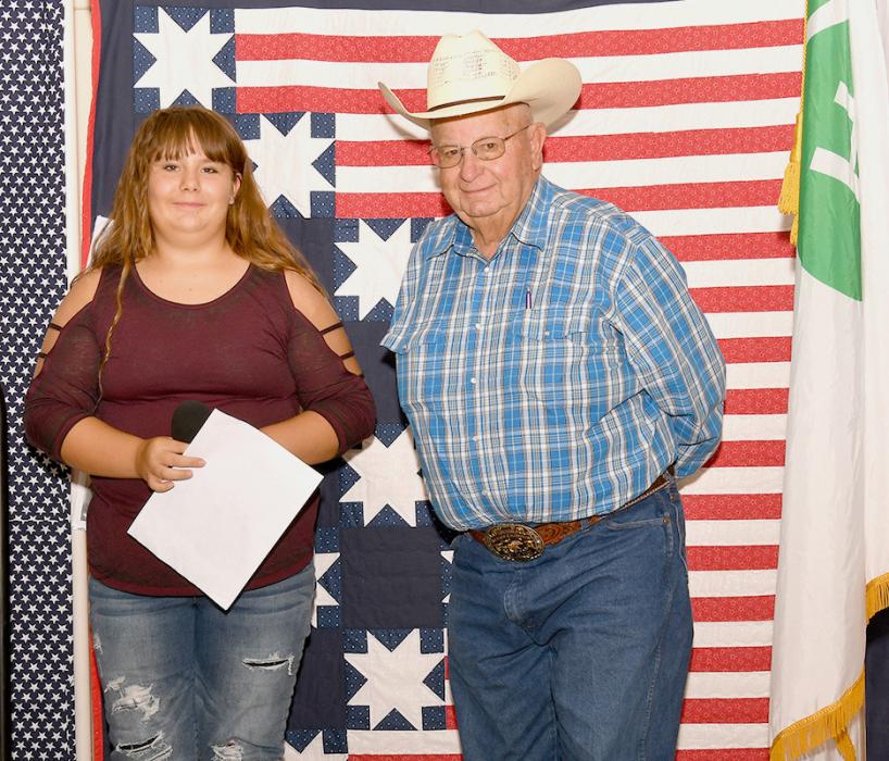 Ruby Shelbourn presents Robert “Butch” Tinant with his Quilt of Valor.
