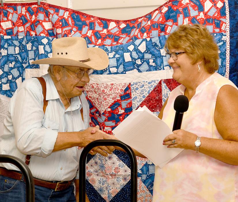 Rhonda Cherry presents Richard Cobb with his Quilt of Valor.
