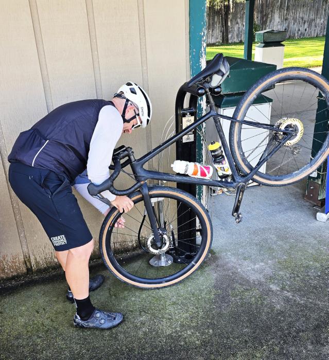 A cyclist airs up the tire on his bike at the Trail Head Park. A repair station was set up with wrenches, air, and other tools to help cyclists get down the Cowboy Trail, or anywhere else, for that matter. Photos by Regina Osburn