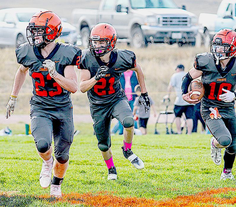Cowboys Jacob Knox #23 and Jasper Roseberry #21, clear a path for ball carrier Cooper Fay #10.