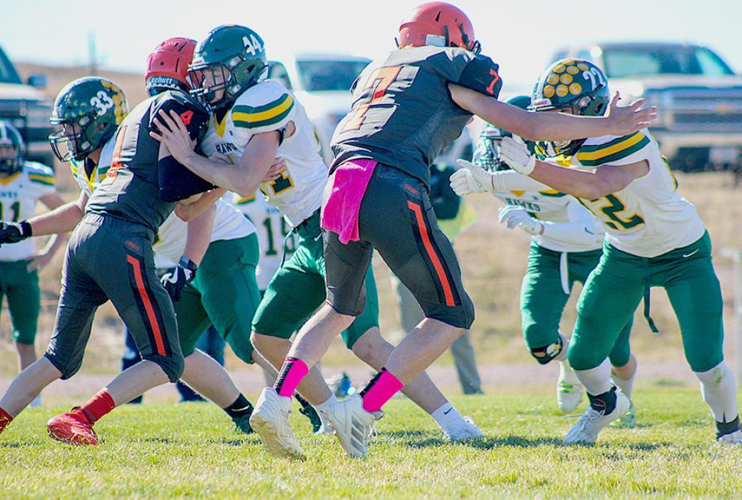 Byron Skinner #4 and Drew Farrell #7 working on the line against the Hawks. The Cowboys ended their season after their matchup against the Hawks who won 28-12.