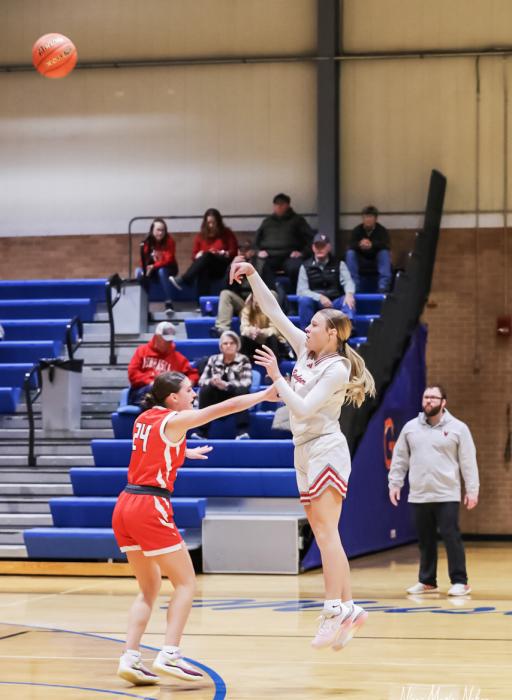 Sophomore Joni Cox #0l with a beautiful 3 pointer.