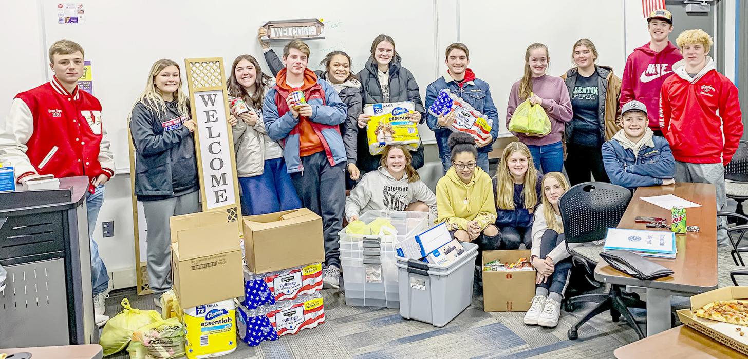 Interact Club members with the many items they’d purchased and donated to RDAP; items that survivors and their families can use as they escape abusive situations.