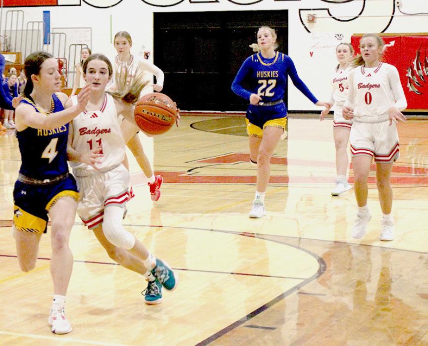 Paige Sprenger bringing the ball up the court trying to get past her defender for an easy lay-up. Photos by Mary Reagle
