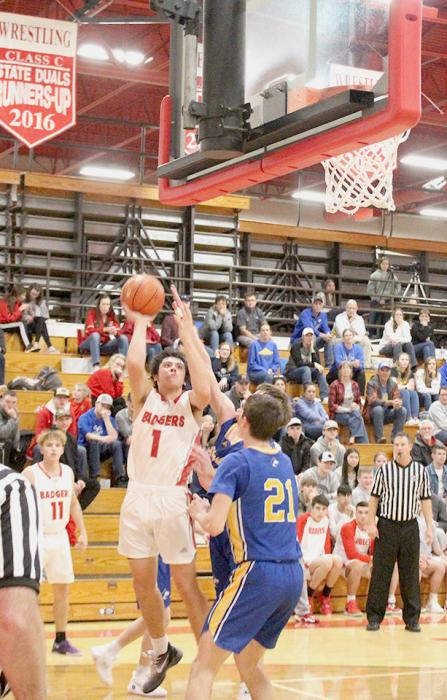 Andon Olson with a little jumper under the basket with his opponents trying to protect the hoop.
