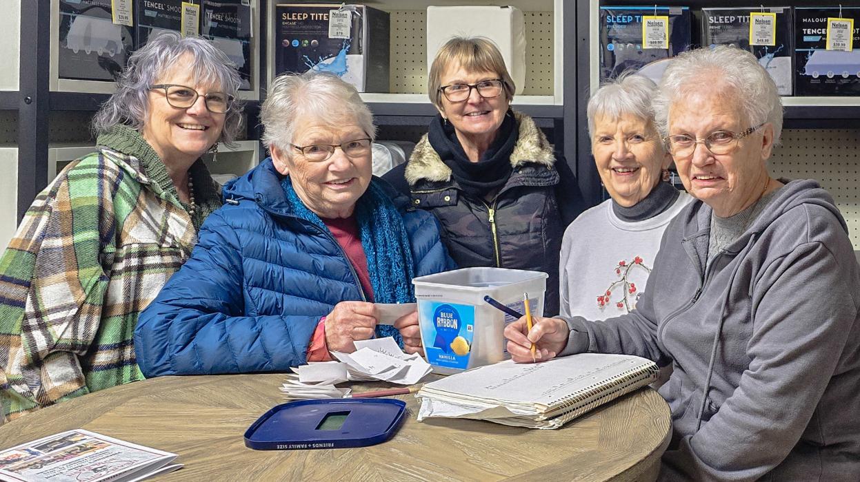 The Sandhills Piecemakers Quilt Guild is pictured from L to R: Sonja Lurz, Carolyn Wickett, Deb Galloway, Shirley Schuman, and Bev Kockrow. They are tallying up the results from the People’s Choice Quilt Show held during the Bull Bash. Photo by Laura Vroman