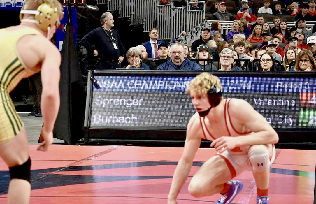 Will Sprenger wrestled at 144# and finished in second place at NSAA State Wrestling, above. Across the top, Sprenger competes with Burbach. Photos by DeanNa Fowler