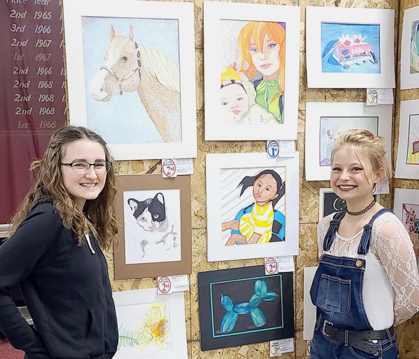 Akosha Ward and Brooke Henkenius, of Valentine, each had two colored drawings completed using markers on display. Akosha drew the horse at top left,and young lady bottom right. Brooke completed the woman and baby top left, and the tuxedo kitty bottom right.