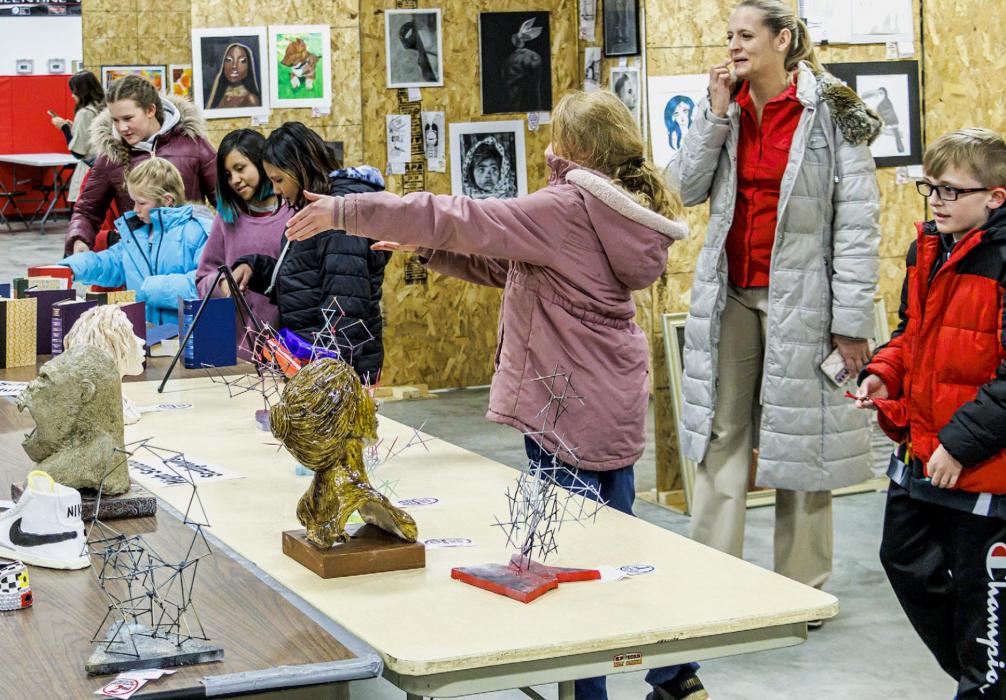 It almost appears as if the art is looking at the viewers from several vantage points - on the wall, and the table.