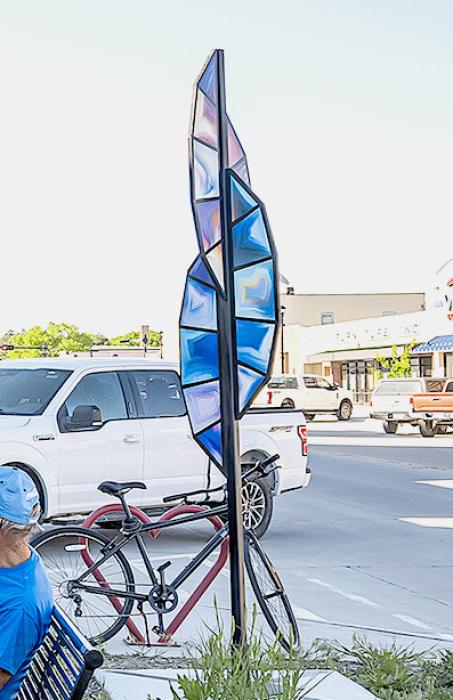 The Feather in front of Broken Spoke Boutique.