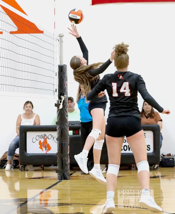 Lilly Ravenscroft tips the ball back across the net against the Rams, while her sister #14 Kayleigh covers. Photo by Shontell Rosberry