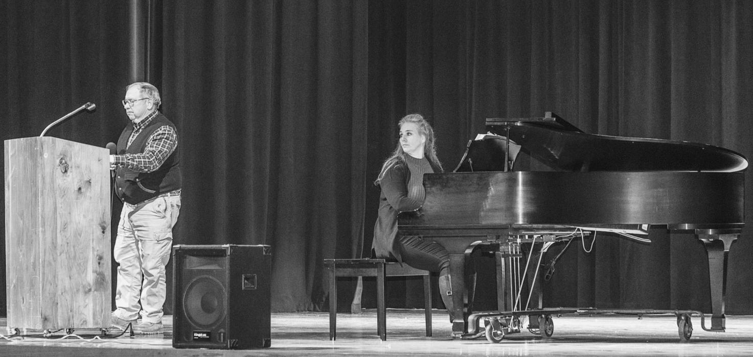 Closing out the evening’s program, Jon Bice signs with Gwen Wenig accompanying. The theme for the New Year eve program was PEACE! Photos by Laura Vroman