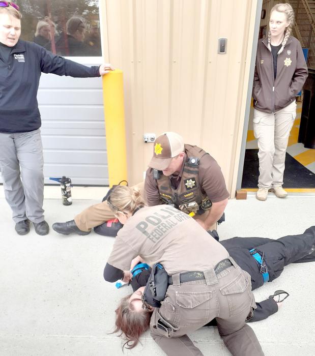 U.S. Fish and Wildlife Refuge Officer Kim Chadwick and Cherry County Sheriff’s Office Chief Deputy Wickman work together to save their victim as Instructors Kohlman and Doyle look on.