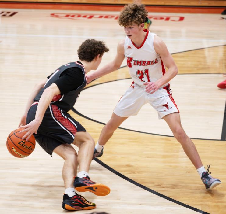 Dominic Beebout #4 hides the ball from his defender in the game against Kimball. Photos by Kinsey Buechle