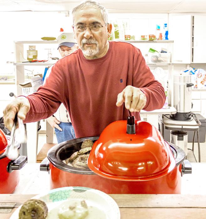 Kent Lopez serves up a choice of biscuits and gravy, or a nice stack of pancakes for the annual 1884 Day Breakfast.