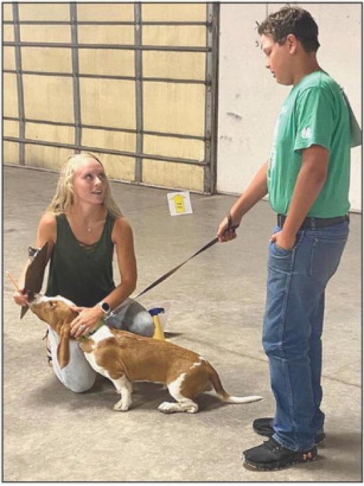 Jaeden Garwood visits with the judge during the puppy class.