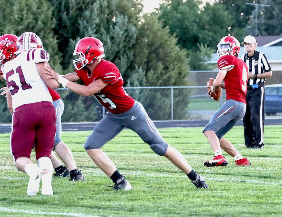 Quinton Nelson #75 holds back Centura as Trace Buechle #9 gets ready to pass.