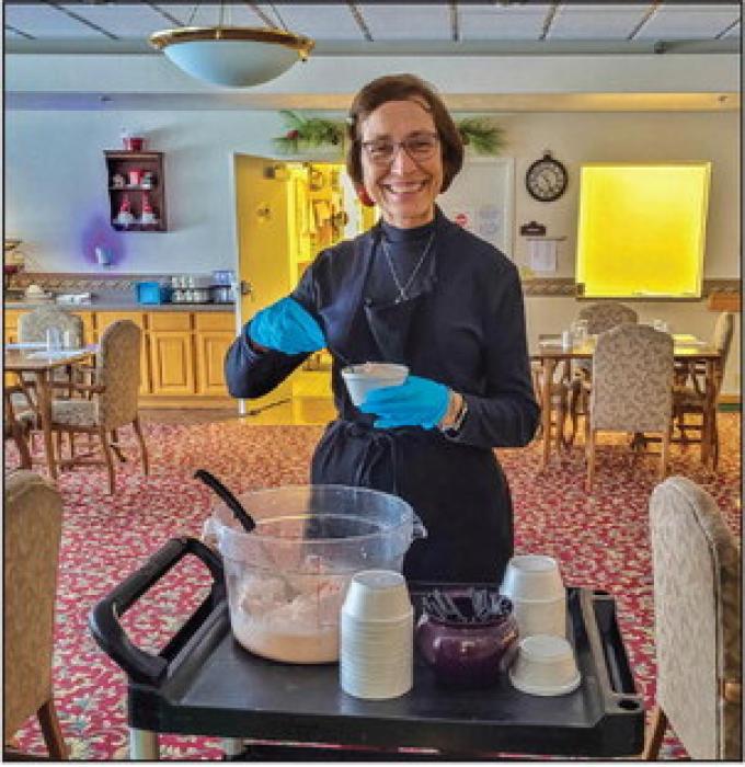Cherry Hills Administrator Sally Conner prepared snow ice cream for the residents after a record setting snowfall.