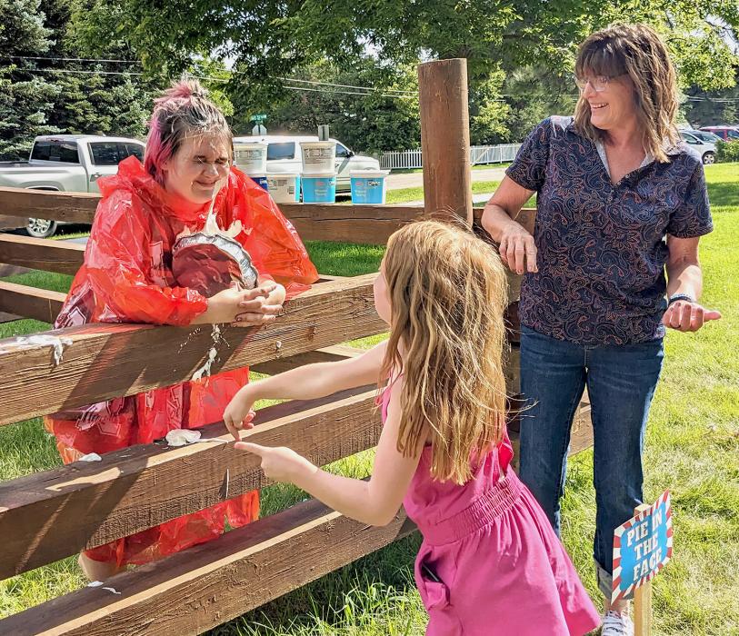 Lilybet Rolfe is being pied in the face at their very short Carnival to raise funds for an Ecology Park swing.