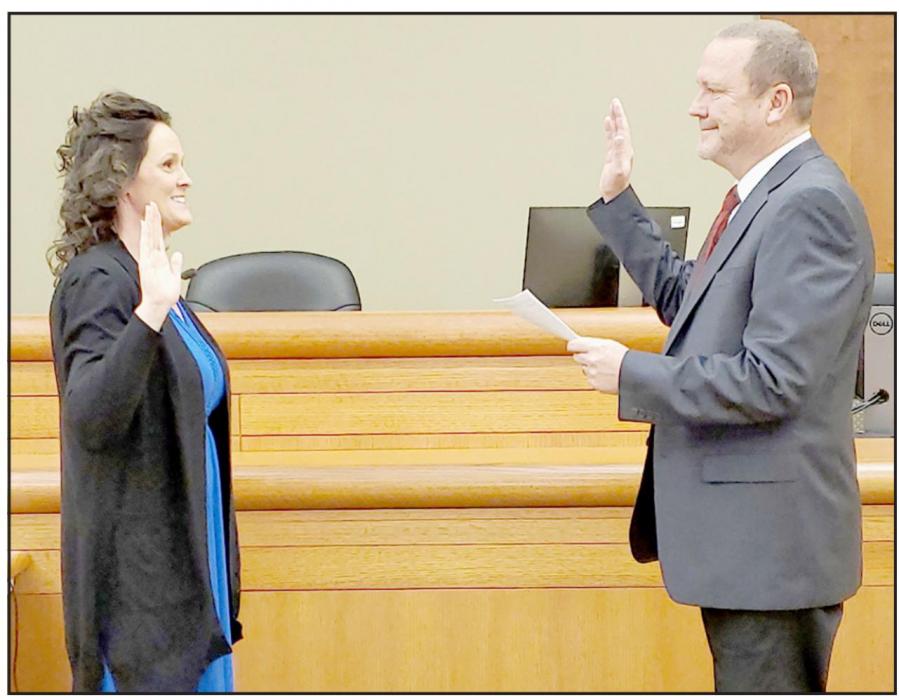 Pictured is Judge James Orr swearing in Clerk Magistrate Debra Hand.