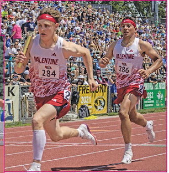 Jekhi Williams hands the baton off to Trystan Beebout in the boys 4x100 Meter Relay.