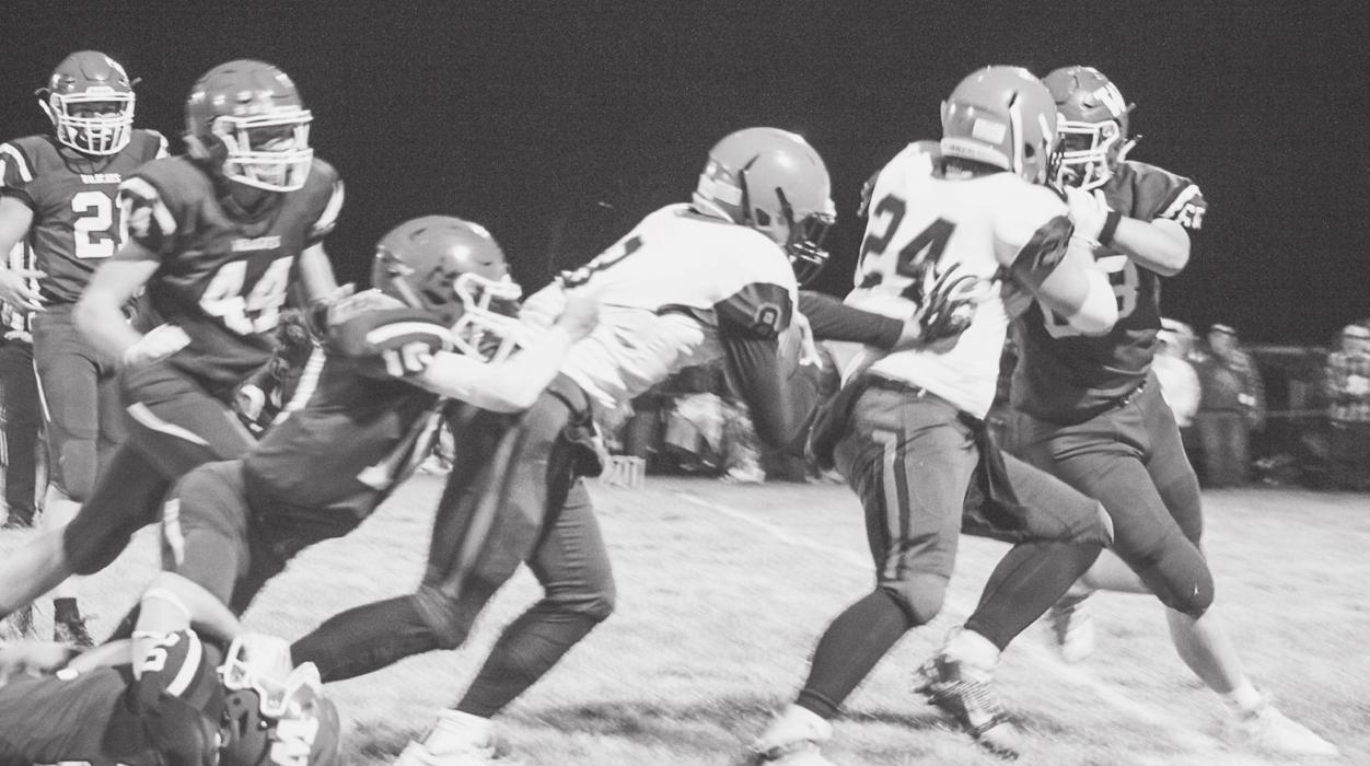 Ball carrier Gage Davis #8 pushes through as Tucker Ravenscroft #24 moves his opponent out of the way. Teamwork!