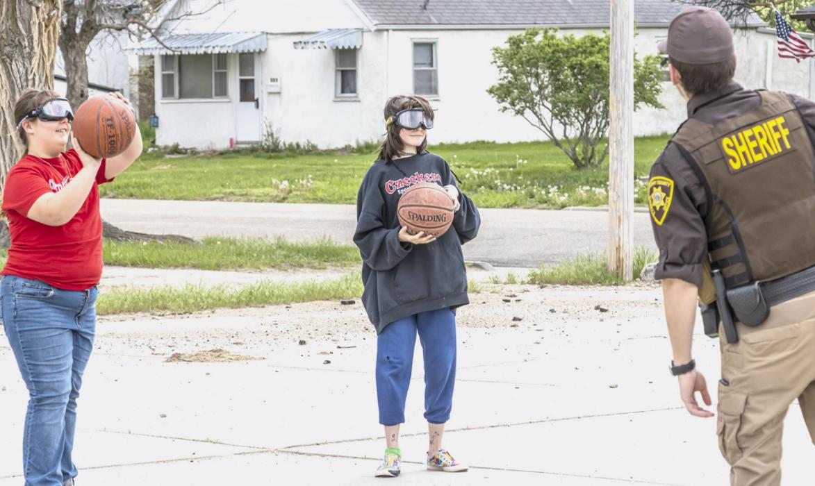 Inebriation goggles test the skill level of students trying to shoot basketball, which only made the game that much more difficult. Photos by Laura Vroman
