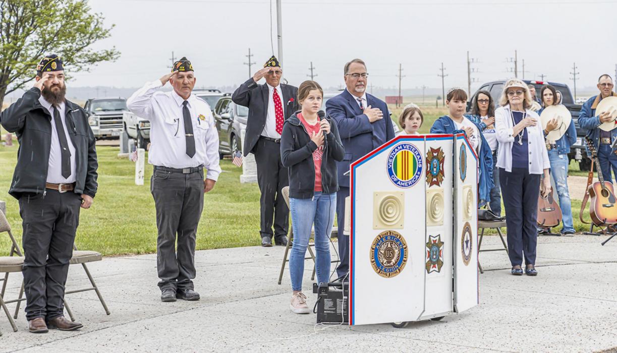 Pictured are from L to R: Monty Krueger, Rex Gallino, Don Nelsen, JoJo Jordan, Pastor Scott McClellen, Little Miss Poppy in Waiting Darby Murphy, Little Miss Poppy Ruby Shelbourn, Ginny Nelsen, Kitty and Rick VanderWey.