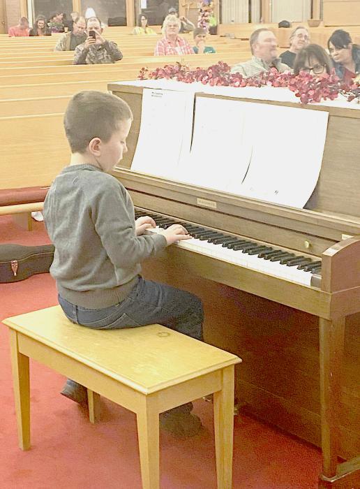 Cam Brashears performs a Clover Kid piano solo.
