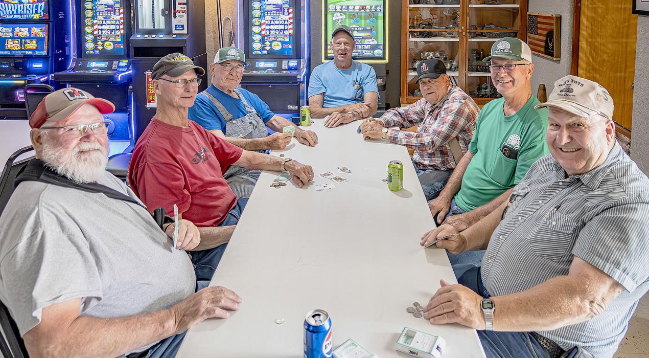This group was busy playing Double Deck Sheep Head inside the Vets Club...to make a little money and have some fun. They are pictured from left around to right: Bill Klassen, Kent Preister, Marvin Weeder, Tim Preister, Doug Kuester, Terry Oberhauser, and Richard Bender. Most of them have semi retired from farming.