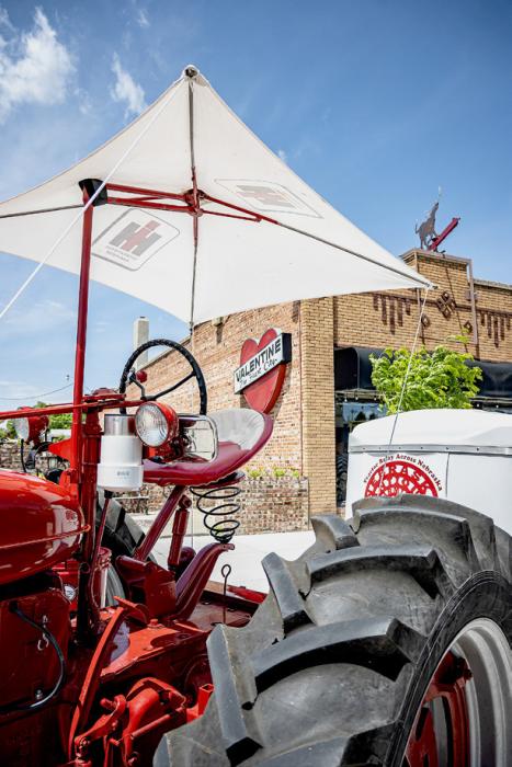 Covered cabs were coveted back in the day! Their ingenuity at providing shade while doing their work was evident with this fabric canopy held down with rope - compared to the air conditioned cabs of today! Long live farmers and ranchers!
